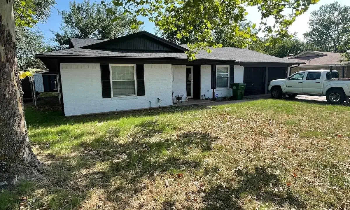 Professional roofing crew working on a residential roof in Jenks